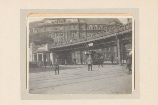 Street scene with tram and elevated railway line