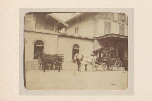 Carriage with a three-horse team in front of a building