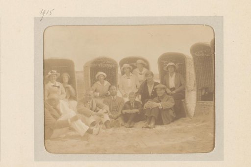 Group Portrait of a Company Sitting in and Around Beach Chairs