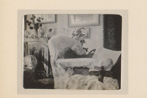 Man sleeping in a chair, newspaper on his lap