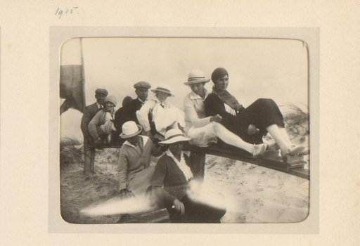 Group sitting on a wooden fence, probably in the dunes