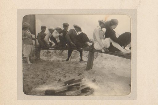 Group sitting on a wooden fence, probably in the dunes