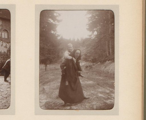 Portrait of a woman with a child on her back in a mountain meadow