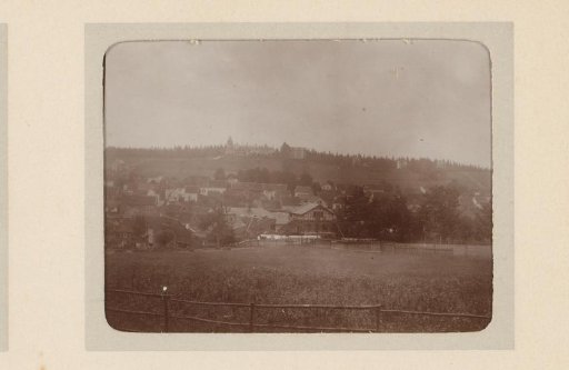 View of a village in a valley, with a country house on the hill