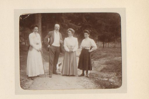 Portrait of two women, a man and a girl on a forest path