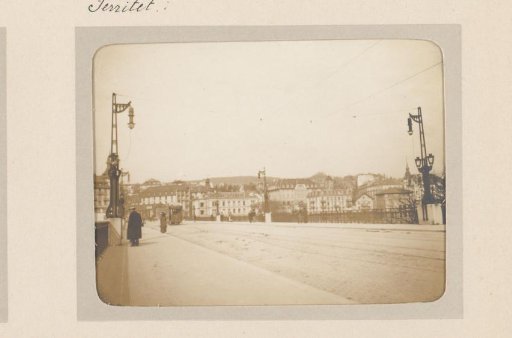View of a wide bridge over which an electric tram is passing