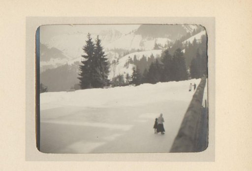 Skating People on a Frozen Mountain Lake
