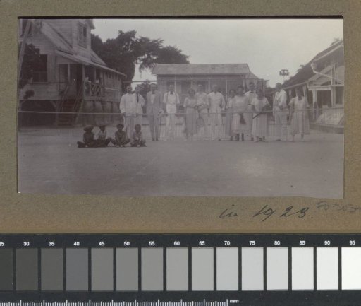 Group with tennis rackets on a tennis court in Suriname