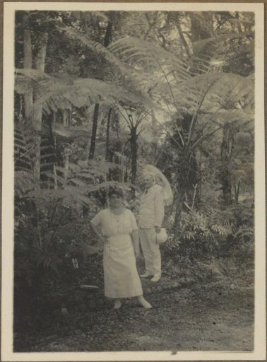 Man and woman sitting on river stones, presumably in the Dutch East Indies
