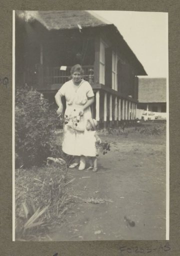 Woman and child of the Janschen family picking flowers in Medan