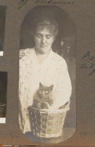Woman holding a cat in a basket