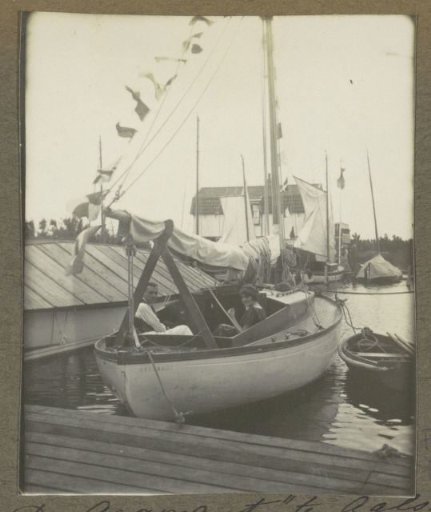 Man and woman in sailing boat 'Argonaut' at a pier in Aalsmeer