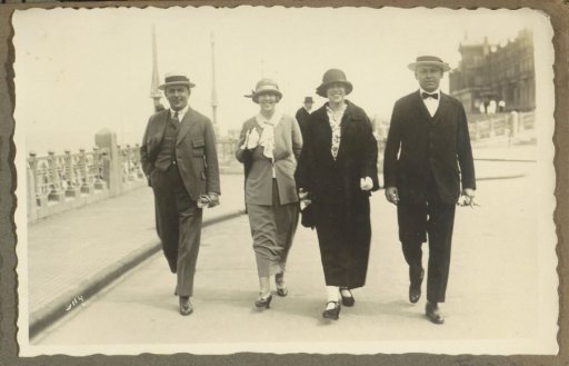 Two men and two women walking on the boulevard of Scheveningen, seen from the front