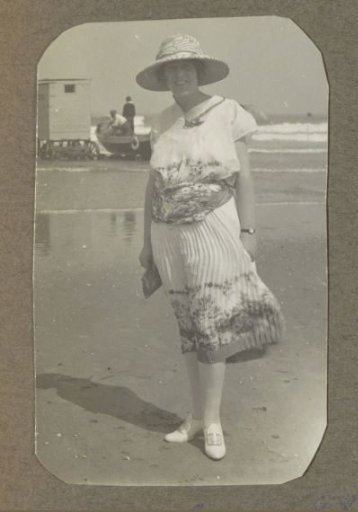 Woman with hat on the beach, probably in the Netherlands