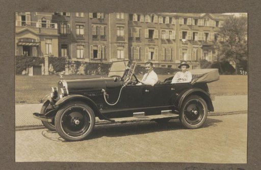Man and woman sitting in a car, possibly in Scheveningen