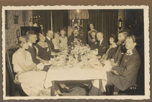 Group at a set table on a festive occasion, possibly in the Netherlands