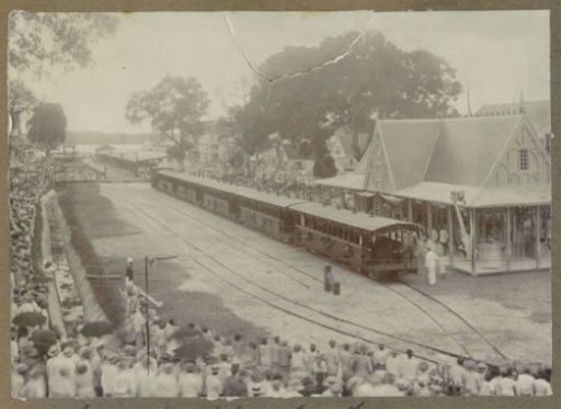 View of a train, station, and crowd at Vaillantsplein in Paramaribo at the opening of the Lawa railway (Landsspoorweg) on 28 March 1905