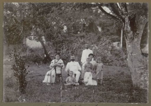 Group with three children in a garden, possibly at the estate 'Veldlust' in Suriname