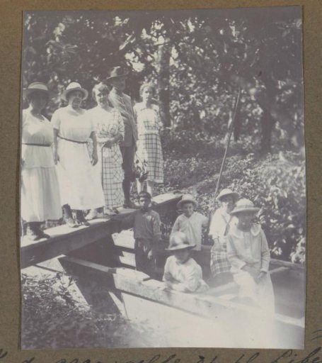 Group in a boat and on a footbridge at plantation 'La Liberté' in Suriname