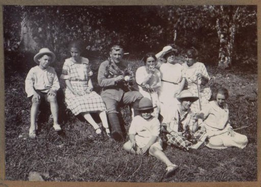 Group sitting in an orange grove at plantation 'La Liberté' in Suriname