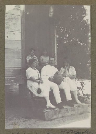 Group sitting on steps at a house in Suriname