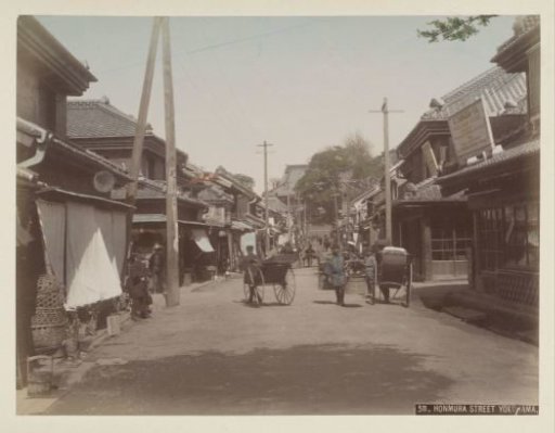 Rickshaw pullers and passers-by in Honmura Street in Yokohama