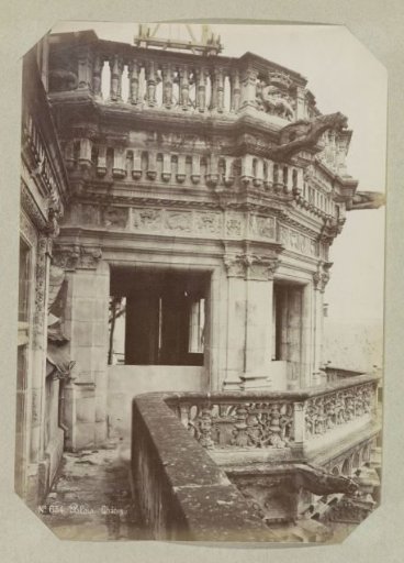 Upper part of the staircase in the Château of Blois with gargoyles and a decorated parapet