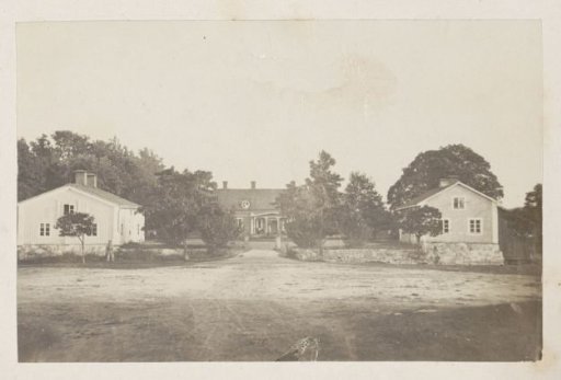 Unpaved Road with Houses on Both Sides and at the End