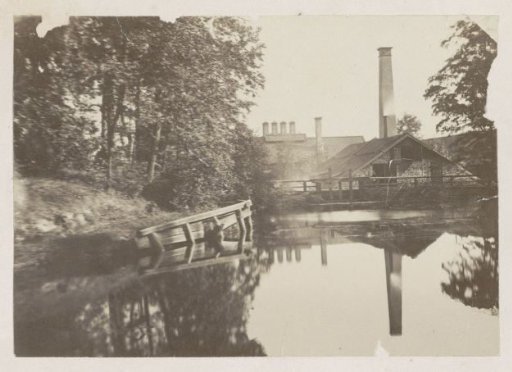Factory Building with a Chimney by a Waterway