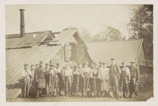 Group Portrait of Workers in Front of a Workshop