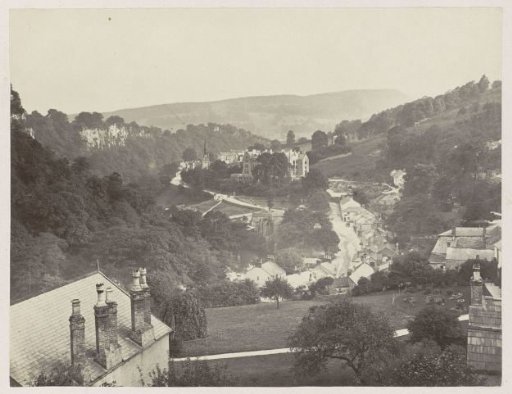 Panoramic view of houses, a church and a road against a ridge in Matlock