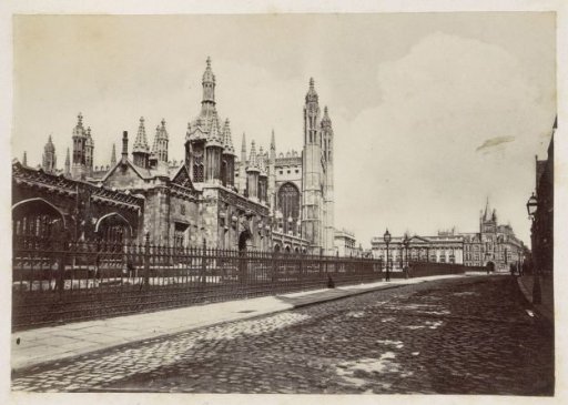 Buildings and towers of King's College in Cambridge, with an empty street alongside