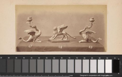 Metal candlesticks in the form of griffins and a lion