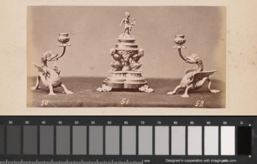 Metal candlesticks in the form of griffins and an inkwell