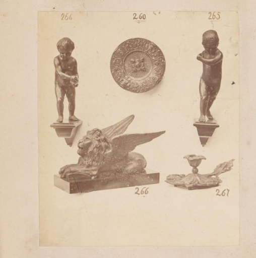 Metal sculptures of a sphinx and a nude, a plate and a candelabrum