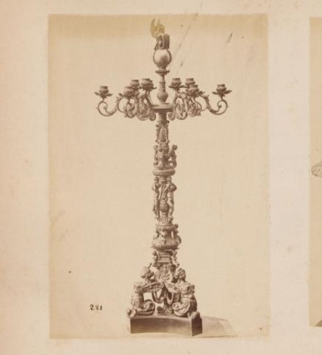 Metal candelabrum on a foot with arms