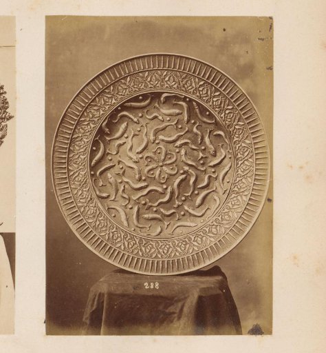 Metal plate with fish decoration