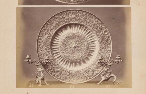 Metal dish with Arabic motifs and metal griffin holders