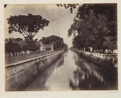 Canal with road and houses in Java