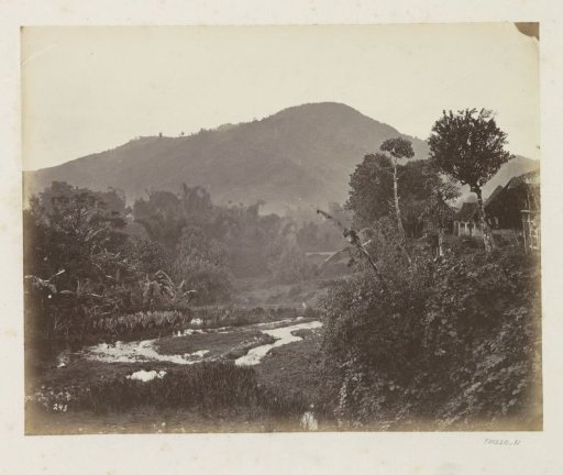 Village by a riverbed at the foot of a mountain in Java