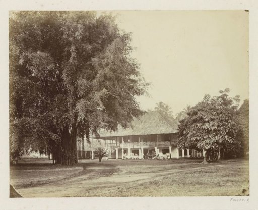 Group with servants in front of a house on Java