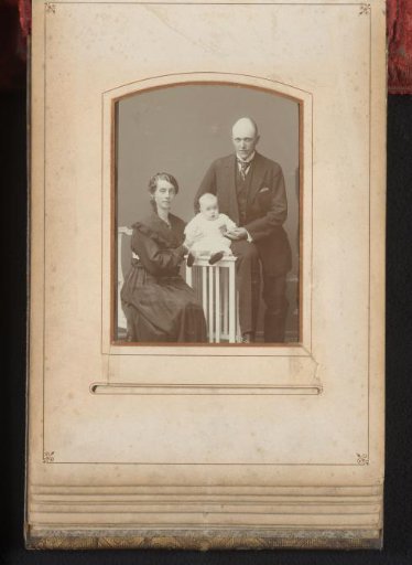 Portrait of a standing man, a seated woman and a baby