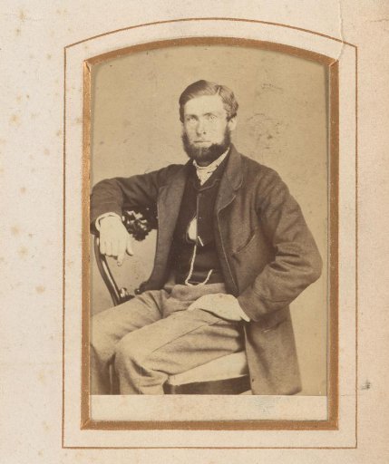 Portrait of a seated man with a beard