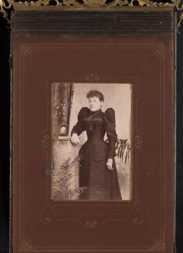 Portrait of a Woman, Standing by a Pillar with a Picture Frame