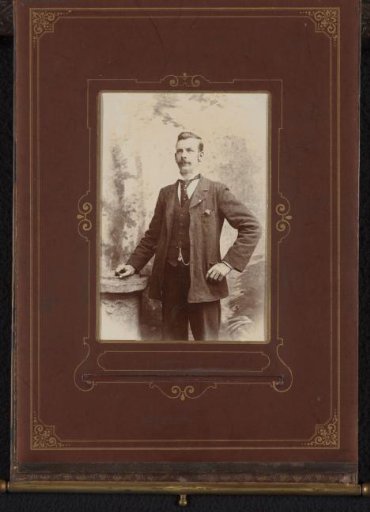 Portrait of a standing man with a moustache