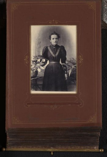 Portrait of a Woman Standing by a Plant