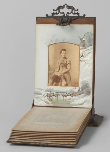 Portrait of a woman standing by a chair