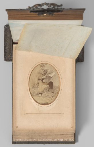 Portrait of a seated man reading a newspaper