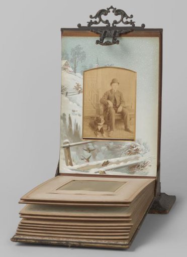 Portrait of a seated boy with a round hat, with a lying dog at his feet