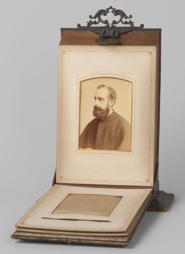 Portrait of a bearded man holding a book